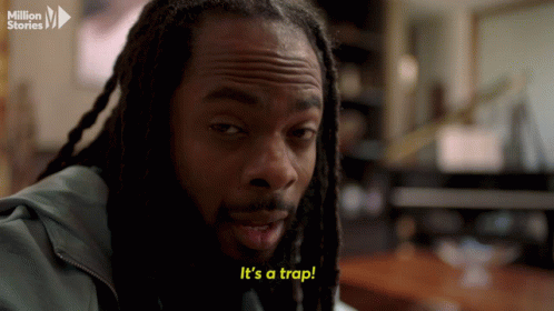 Man With Dreadlocks Says Its a Trap in Yellow Letters