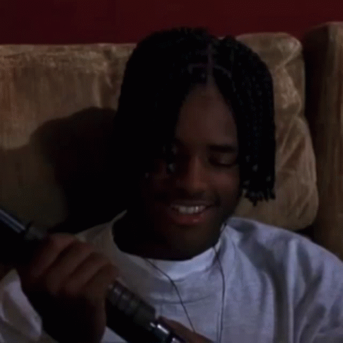 Man With Dreadlocks Sitting On Couch Looking GIF