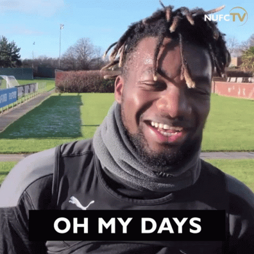 Man with Dreadlocks Smiling at Oh My Days Sign