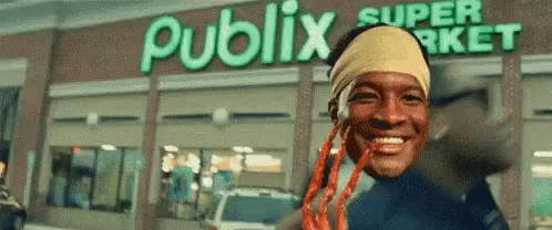 Man With Dreadlocks Smiling in Front of Publix Super Market