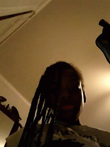 Man with Dreadlocks Standing in Dark Room