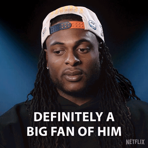Man with Dreadlocks Wearing Fan Hat
