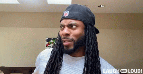 Man With Dreadlocks Wearing NFL Hat