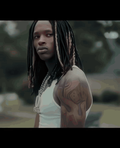 Man With Dreadlocks Wearing White Tank Top and Elise Necklace