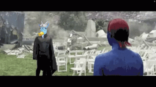 Man With Duck on Head Next to Woman With Blue Body