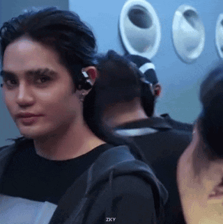 Man With Earbuds Standing in Crowd With Zky