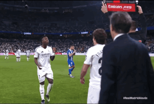 Man with Emirates Sign on Soccer Field