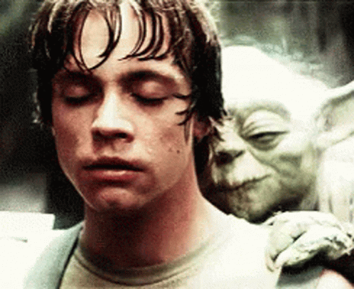 Man with Eyes Closed and Yoda Statue