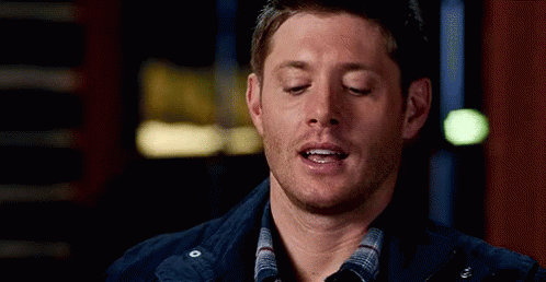 Man With Eyes Closed in Plaid Shirt and Blue Jacket