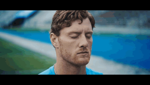 Man With Eyes Closed On Field GIF