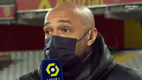 Man with Face Mask and Ligue 1 Microphone