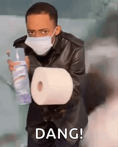 Man With Face Mask Holding Toilet Paper And Spray Bottle GIF