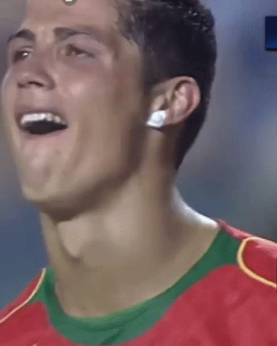 Man With France Lanyard Hugging Another Man on Soccer Field