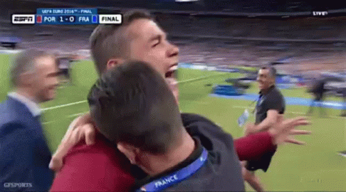 Man With France Lanyard Hugging Another