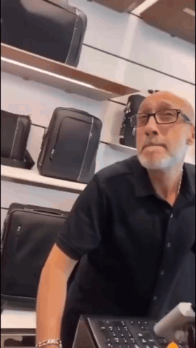 Man with Glasses and Beard at Luggage Counter