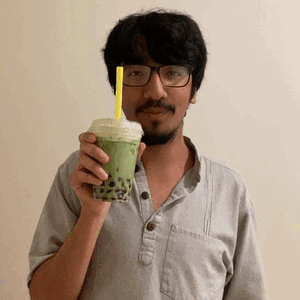 Man With Glasses And Beard Holding Green Tea GIF