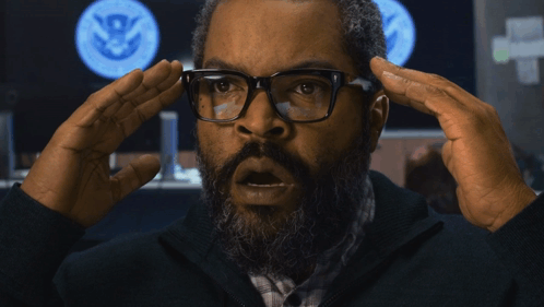 Man With Glasses and Beard Holding Head