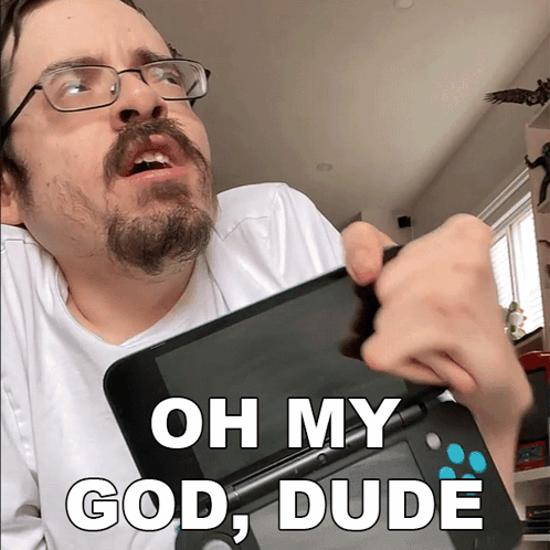Man with Glasses and Beard Holding Nintendo 3DS