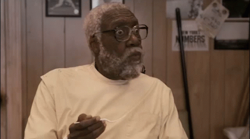 Man With Glasses And Beard Holding Spoon In Front Of Numbers Sign GIF