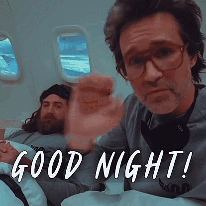 Man With Glasses and Beard in Bed Saying Good Night