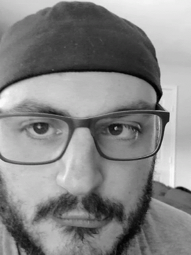 Man With Glasses and Beard in Black Hat