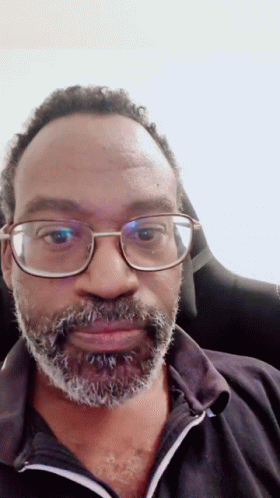 Man With Glasses and Beard in Black Shirt