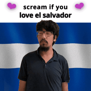 Man With Glasses and Beard in Front of Flag Saying Scream if You Love El Salvador