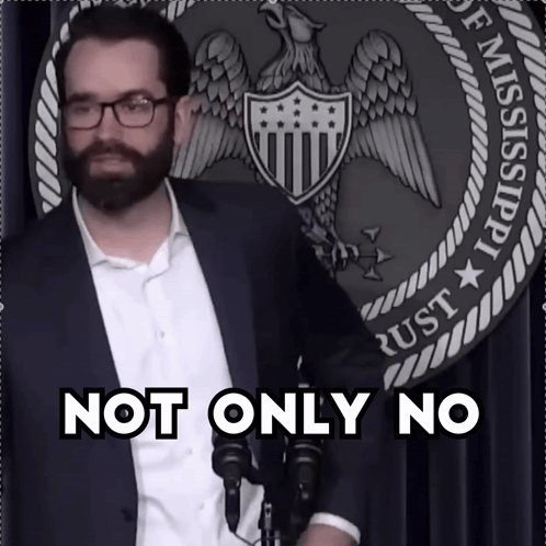 Man With Glasses and Beard in Front of Not Only No Sign