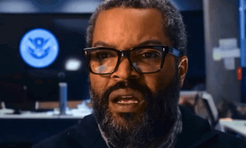 Man With Glasses And Beard In Front Of Screen With S GIF