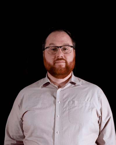 Man With Glasses and Beard Looks at Camera