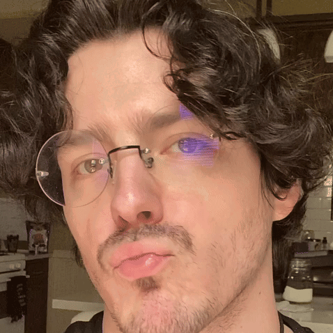 Man with Glasses and Beard Making Face