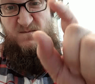 Man with Glasses and Beard Making Funny Face