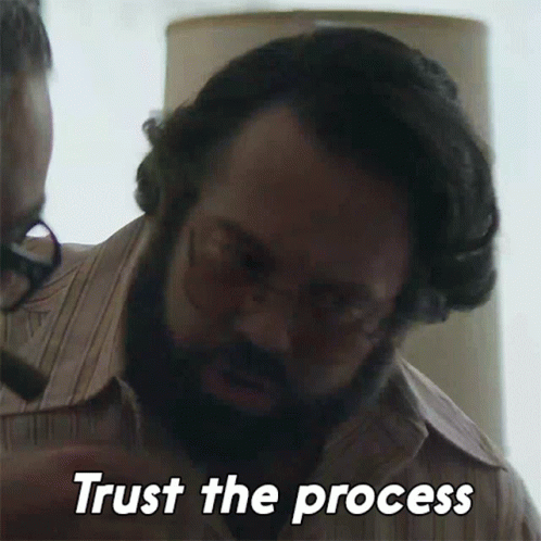 Man with Glasses and Beard Saying Trust The Process
