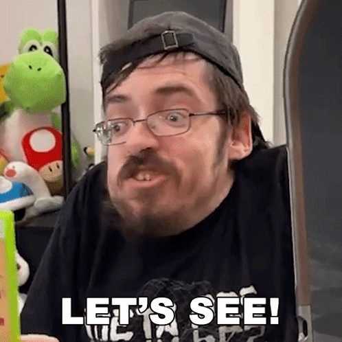 Man With Glasses and Beard Says Let's See