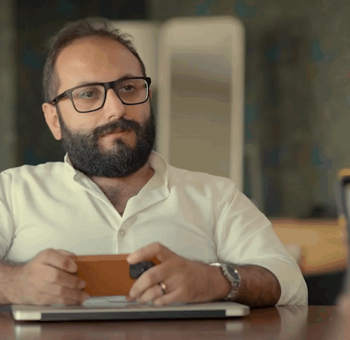 Man With Glasses and Beard Sitting at Laptop