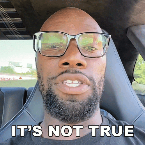 Man with Glasses and Beard Sitting in Car
