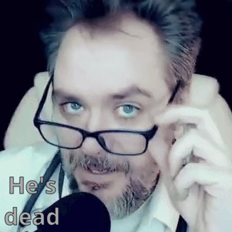 Man with Glasses and Beard Talking Into Mic