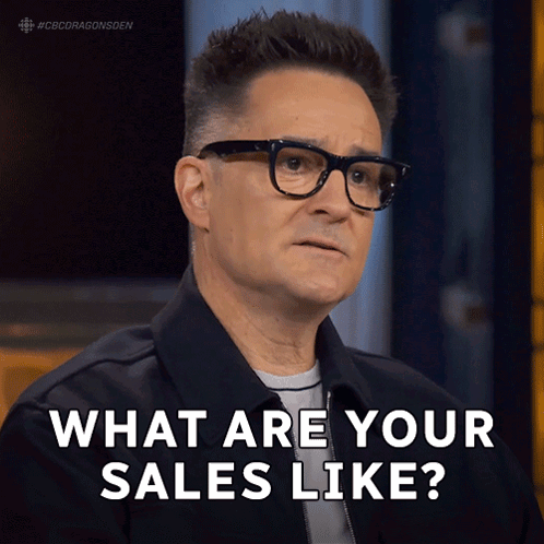 Man With Glasses And Black Jacket Saying What Are Your Sales Like GIF