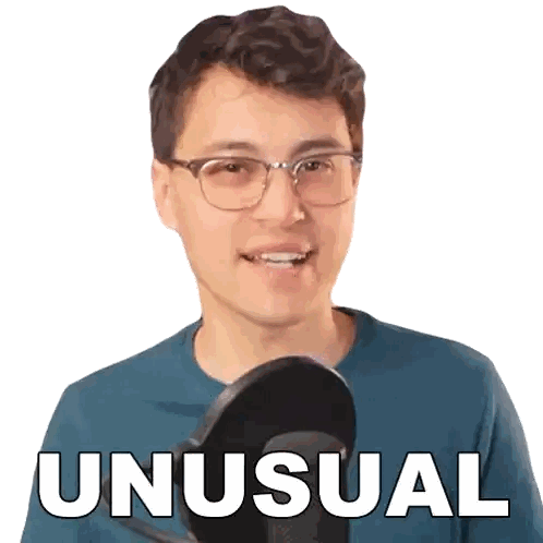 Man with Glasses and Blue Shirt at Microphone Saying Unusual