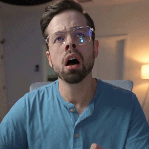 Man With Glasses and Blue Shirt Surprised Face
