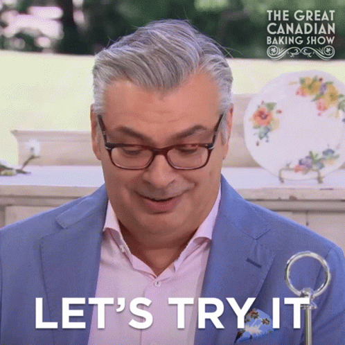 Man With Glasses and Blue Suit Saying Let's Try It