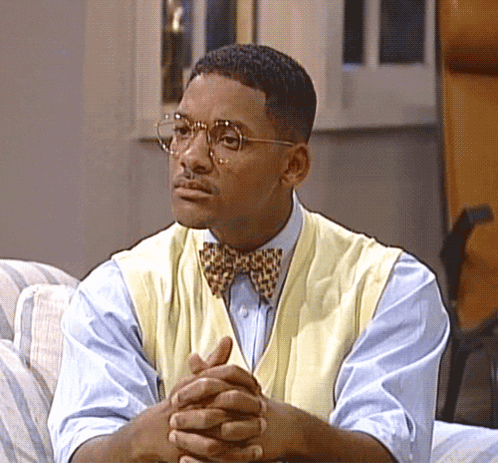 Man With Glasses and Bow Tie on Couch