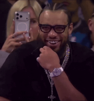 Man with Glasses and Cross Necklace Smiling