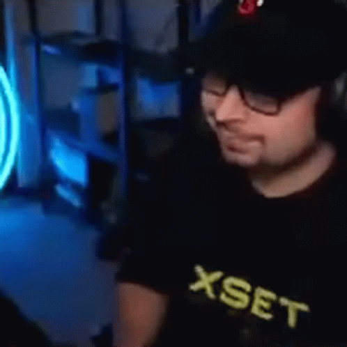 Man With Glasses and Hat at Computer