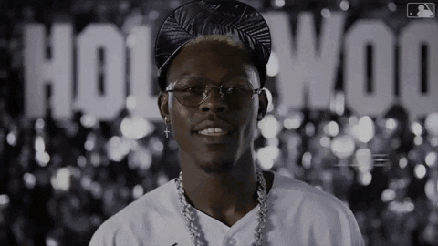 Man With Glasses And Hat In Front Of Hollywood Sign GIF