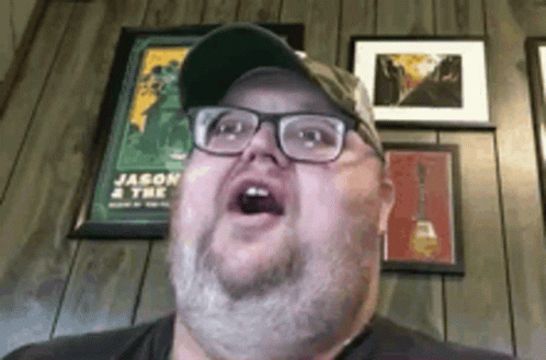Man with Glasses and Hat Making Funny Face