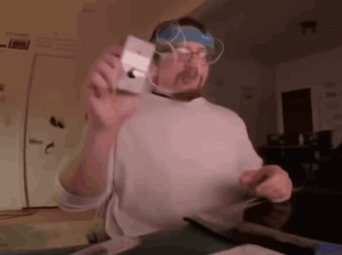 Man With Glasses And Headband Holding Camera GIF
