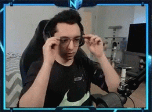 Man with Glasses and Headphones at Computer