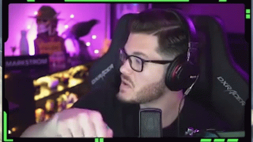 Man with Glasses and Headphones at Microphone