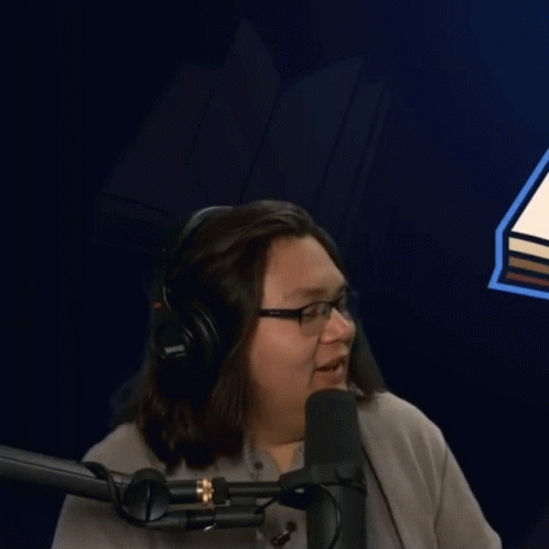 Man With Glasses and Headphones at Microphone